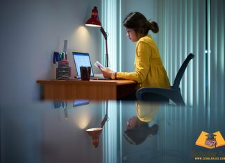 Girl writing expository essay on study desk