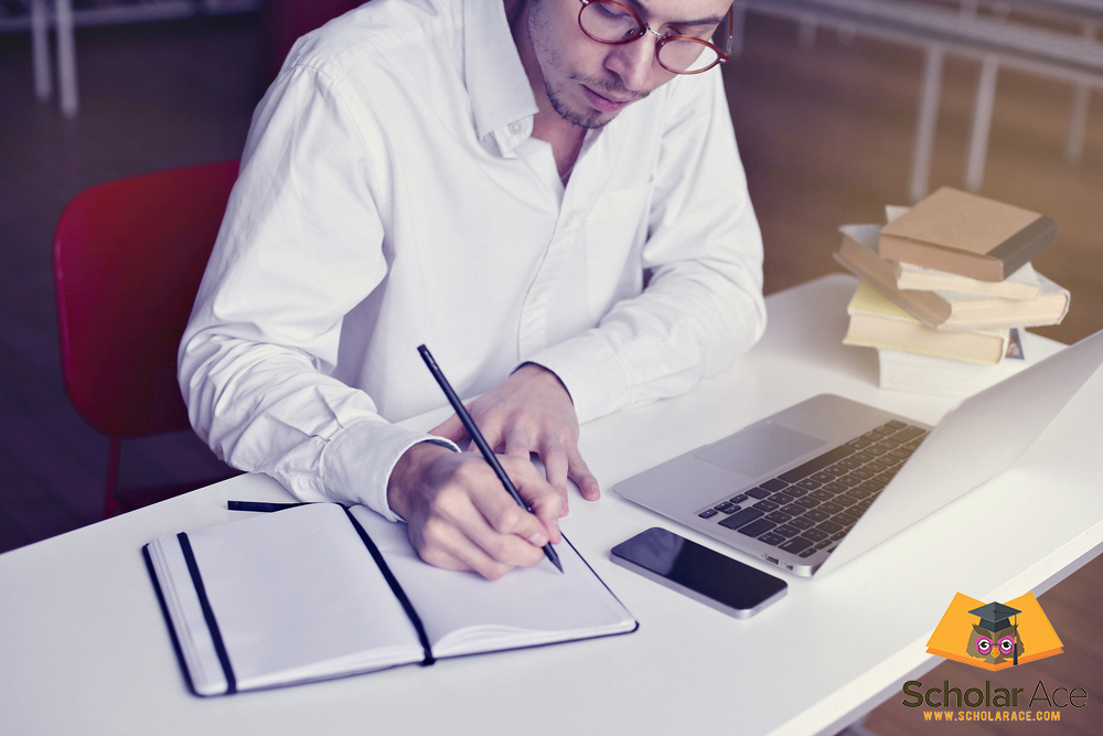 men writing from laptop to notepad