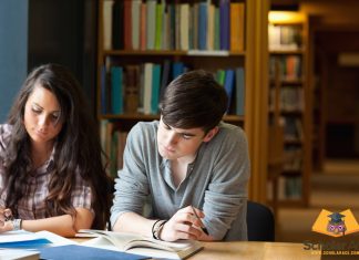 students writing research case study in library